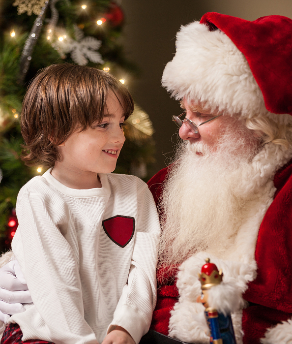 a child looking at a santa claus