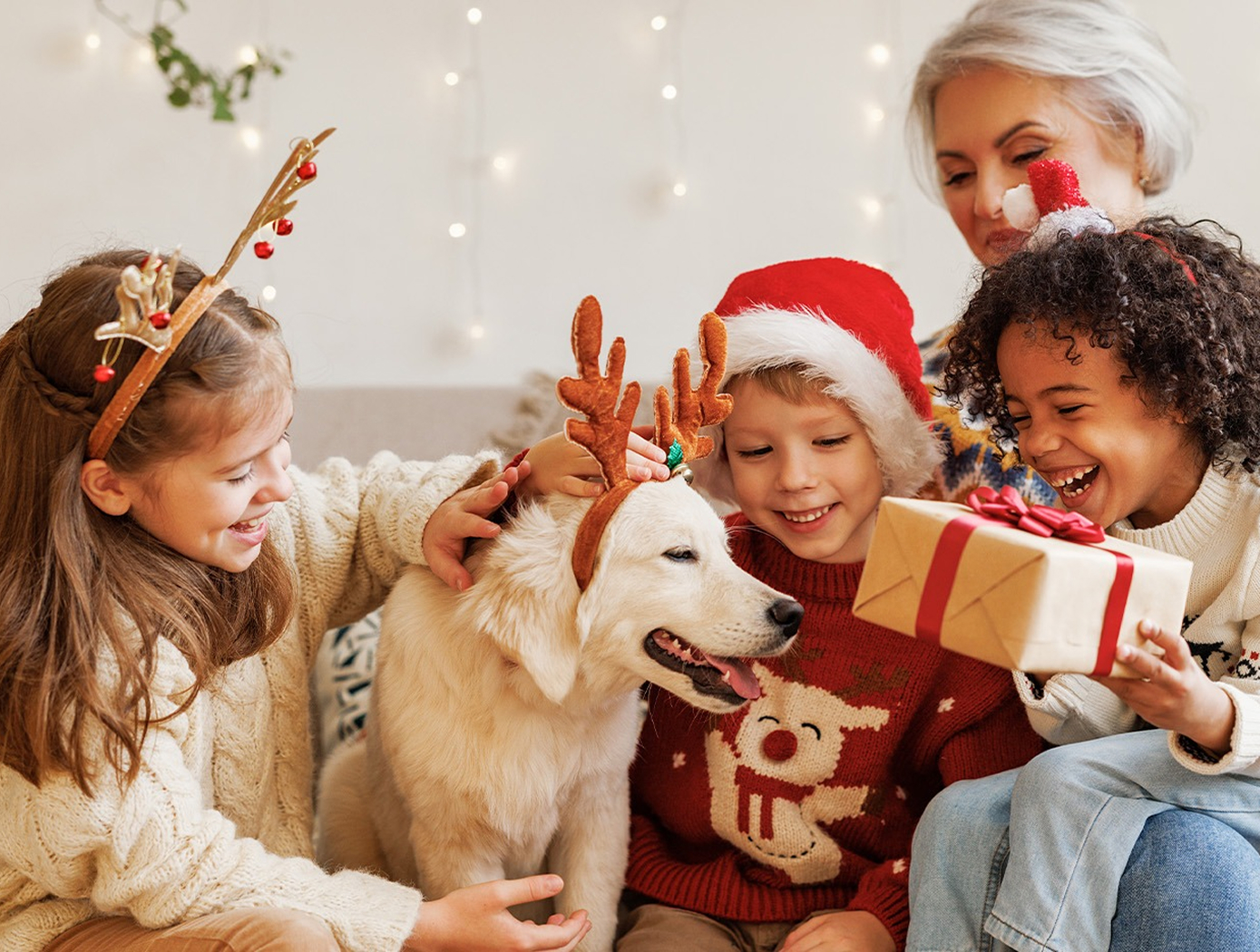 a group of people with a dog and a present