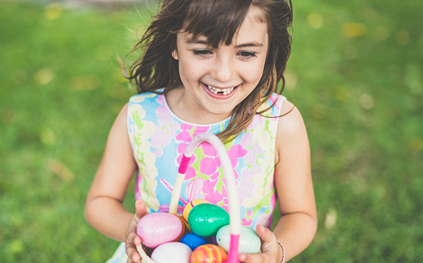 a girl holding a basket of eggs