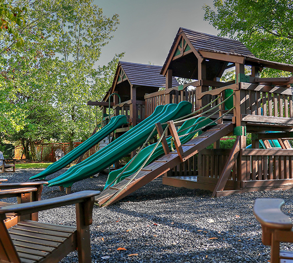 a playground with a slide and a play set