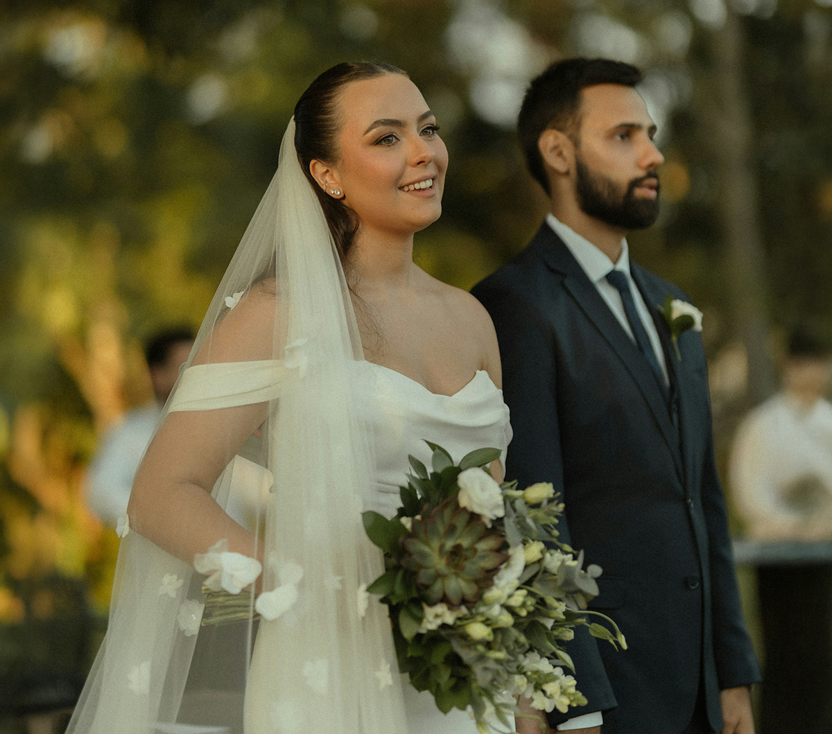 a woman in a white dress with a bouquet of flowers