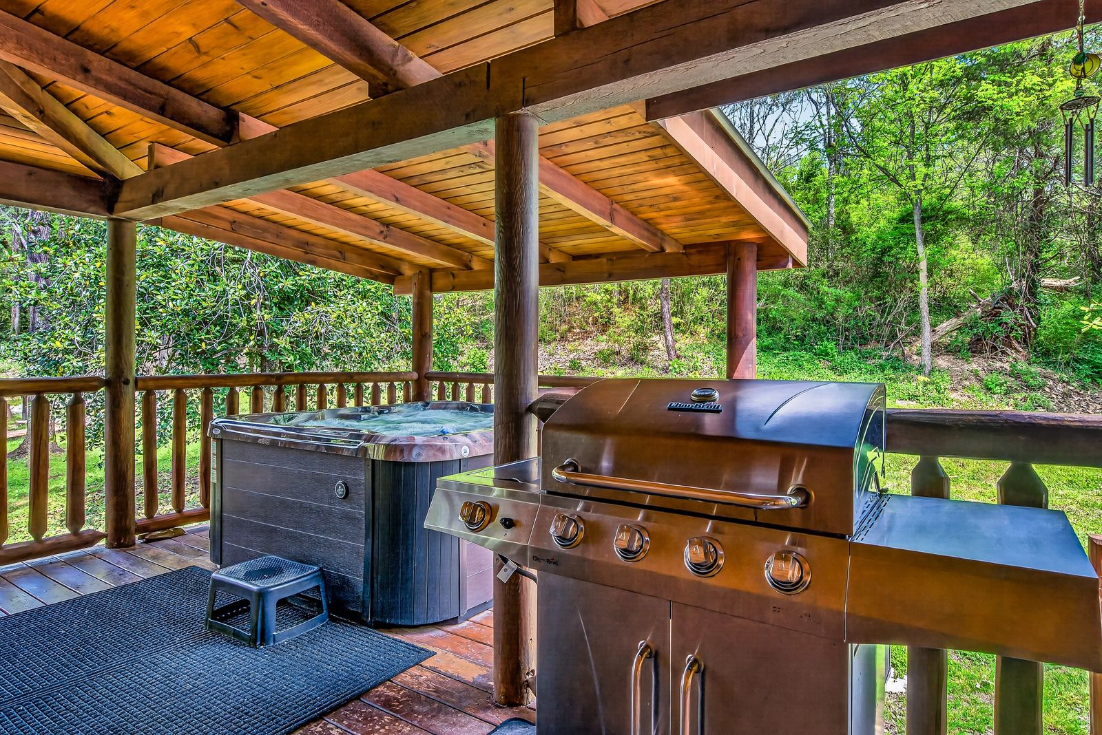 a hot tub and grill on a deck