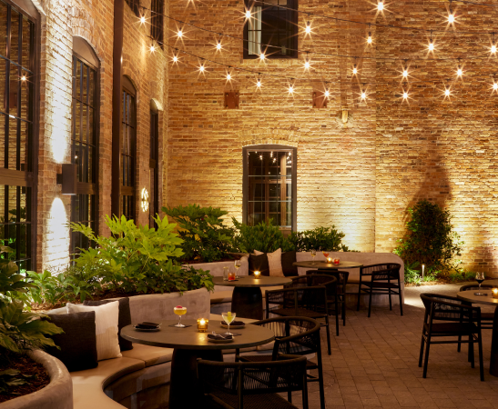 a patio with tables and chairs and lights