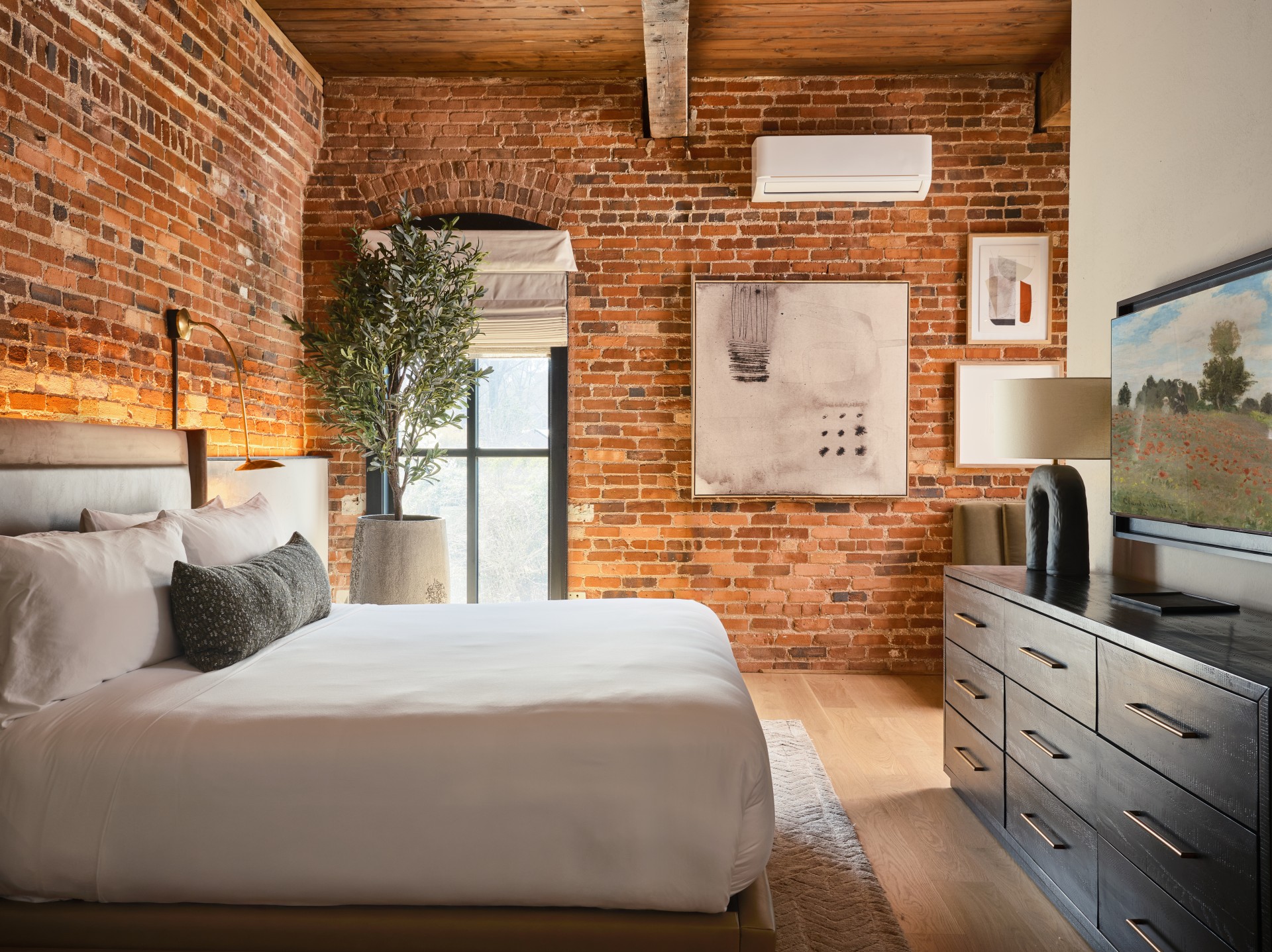 a bedroom with brick walls and a bed
