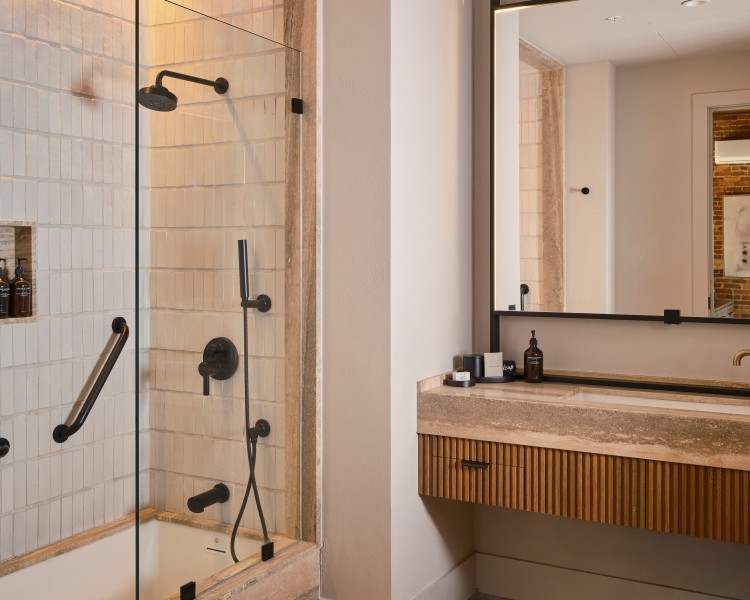 a bathroom with a glass shower and sink