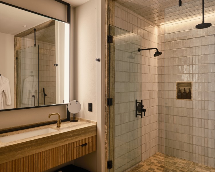 a bathroom with a glass shower and sink