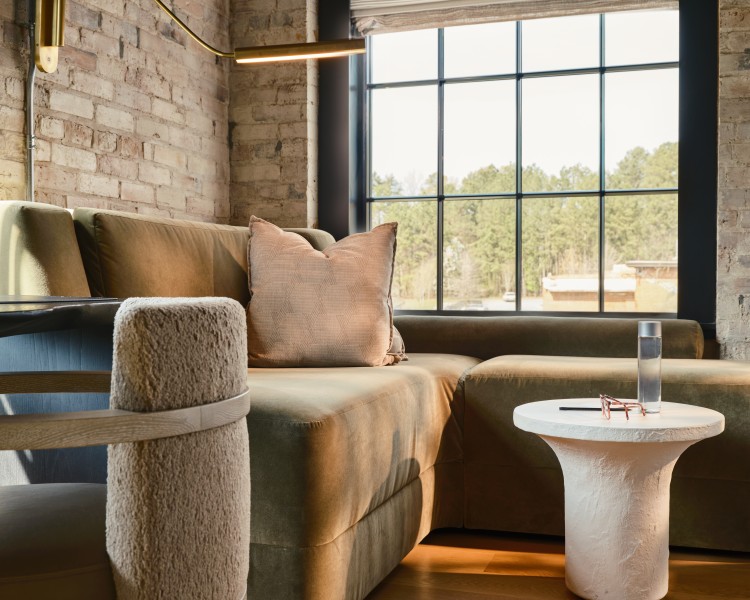 a couch and a table in a room with a window