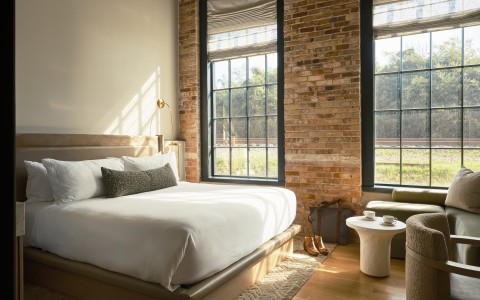 a bedroom with brick walls and a bed