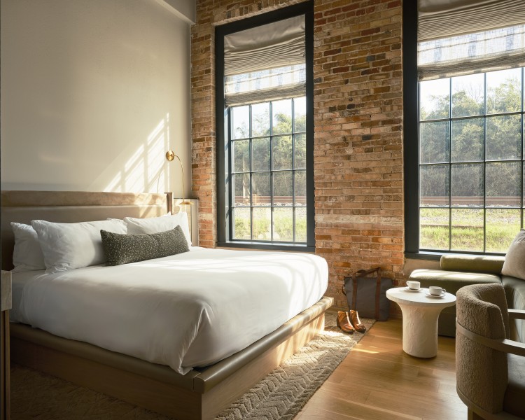 a bedroom with brick walls and a bed