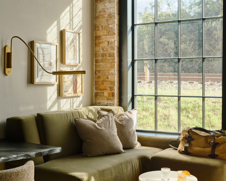 a couch in a room with a table and chairs