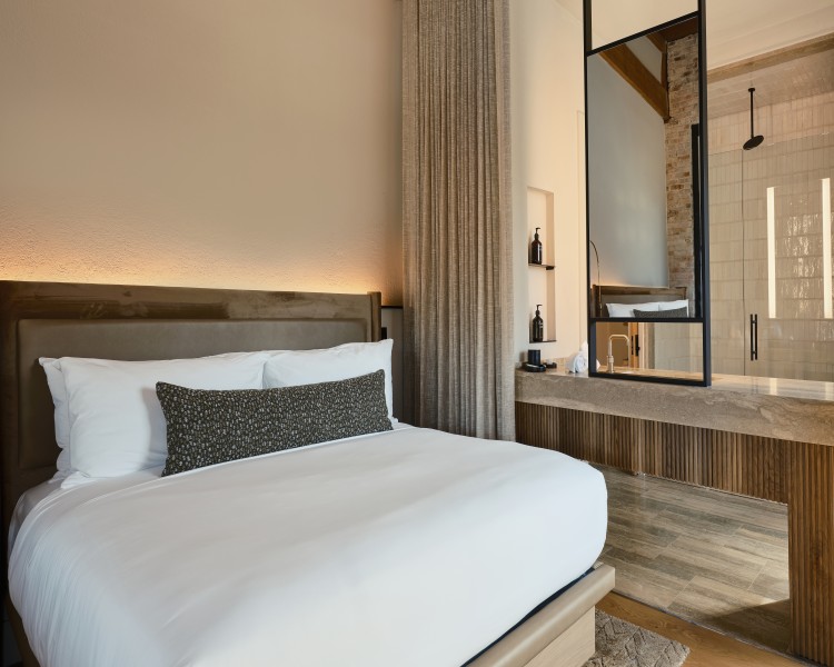 a bed with a mirror in the corner