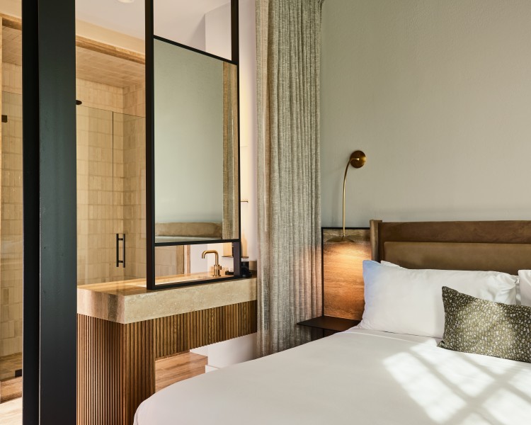 a bed with a mirror and a shower