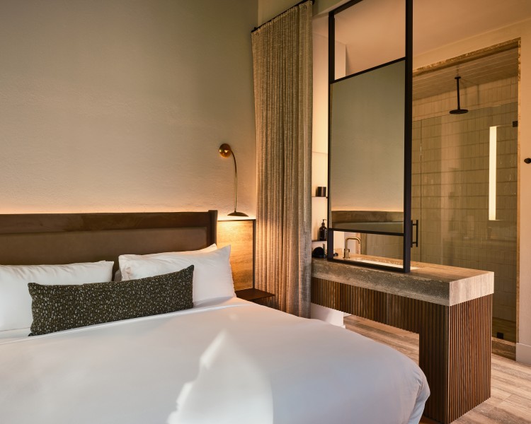 a bed with a mirror in the corner