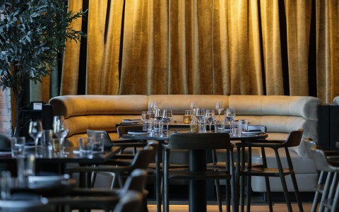 a table with glasses and plates in a restaurant