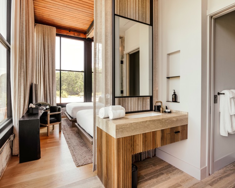 a bathroom with a large mirror and a bed
