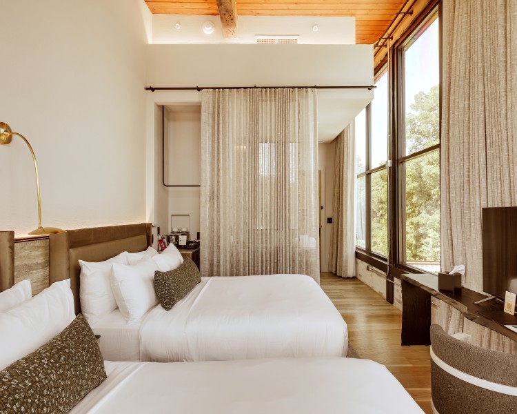 a room with two beds and a window