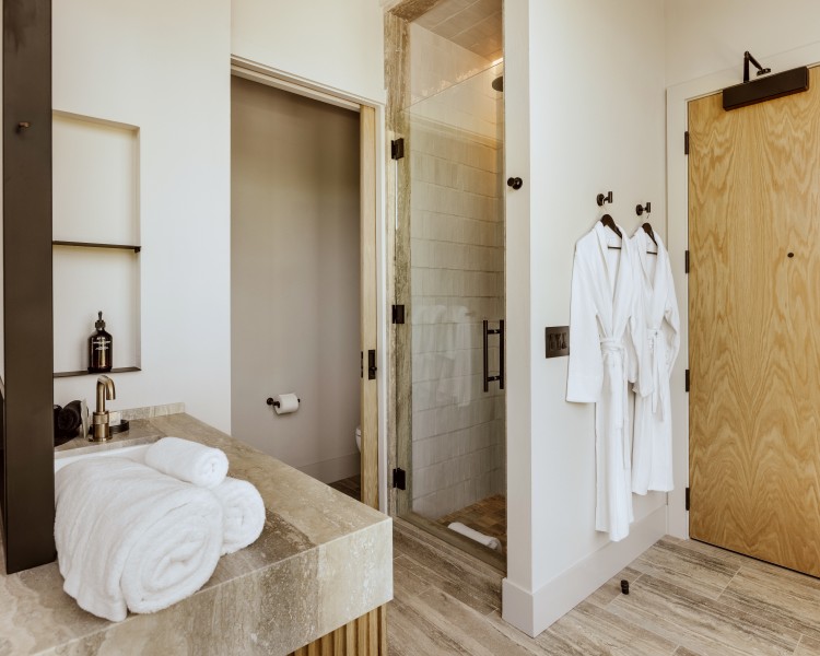 a bathroom with white towels and a shower
