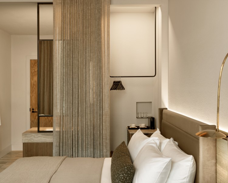 a bed with pillows and a curtain