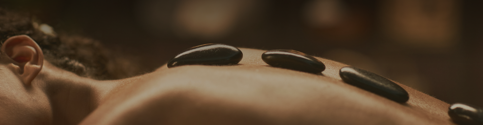 a close up of black stones on a person's skin