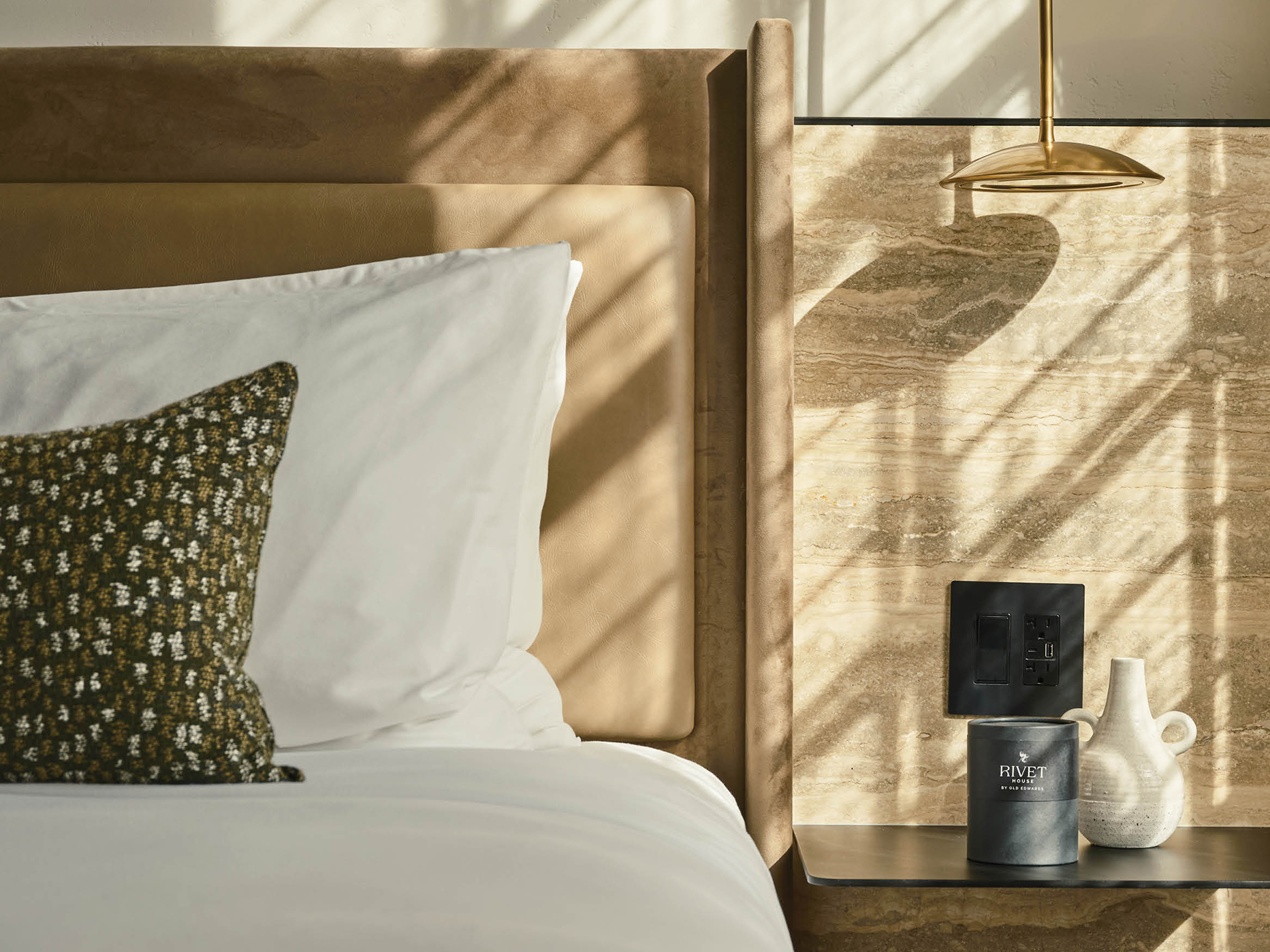 a bed with a lamp and a table