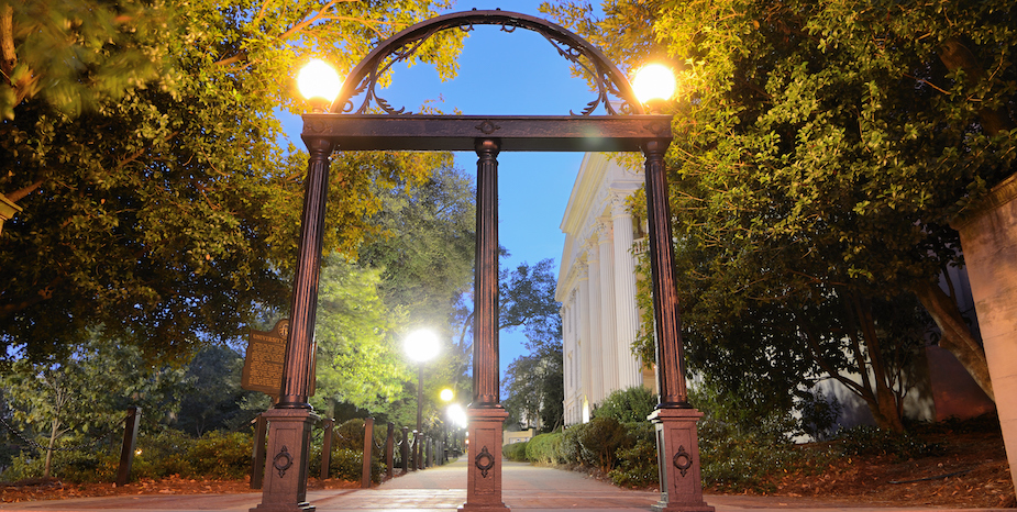 a archway with lights on the side of a sidewalk