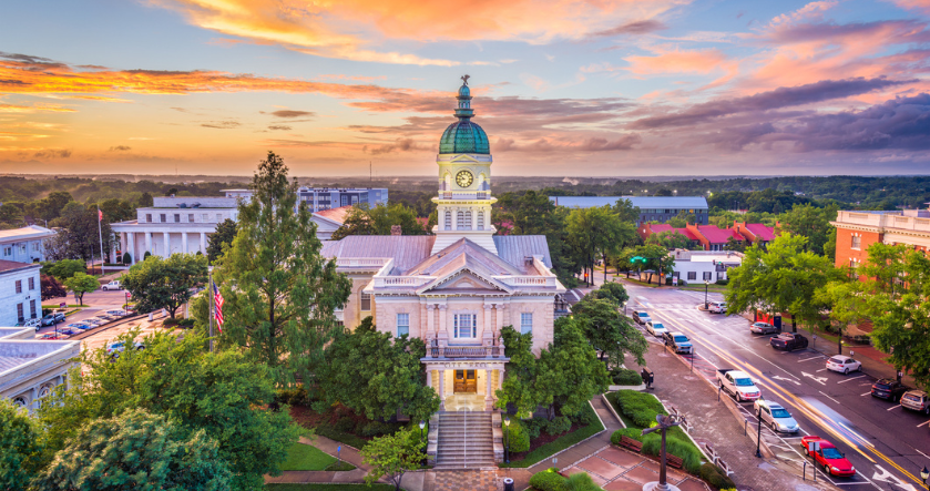 a building with a clock tower and trees