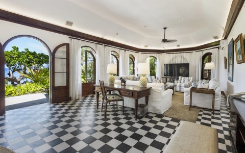 a room with a checkered floor and a table and chairs