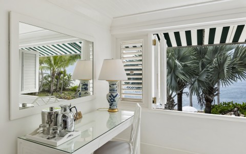 a white room with a mirror and a table