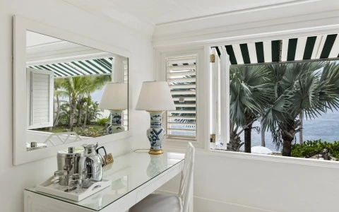 a white room with a mirror and a table