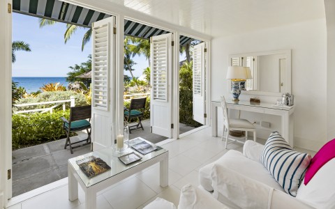 a room with white furniture and a table