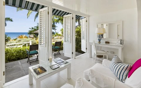 a room with white furniture and a table