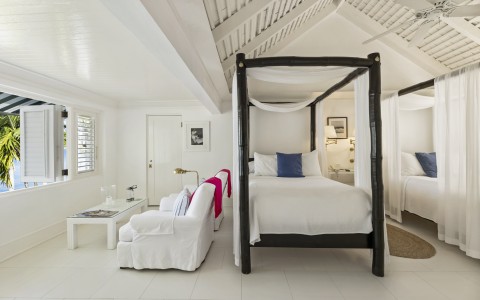 a white room with a bed and a couch