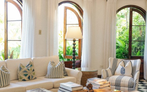 a living room with white couches and a coffee table