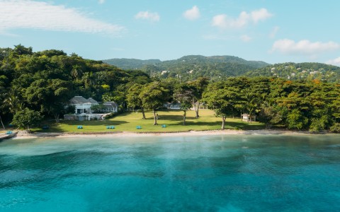 a body of water with a house and trees