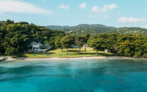 a body of water with a house and trees
