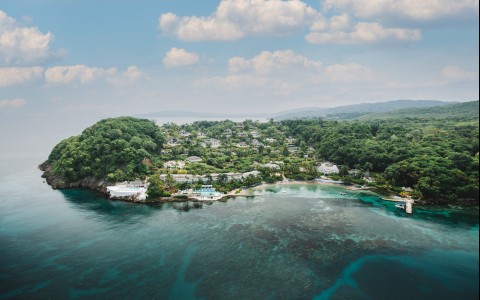 a body of water with houses and trees
