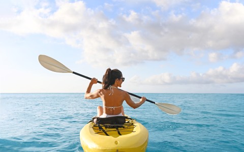 a woman in a yellow kayak