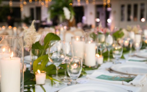 a table set with plates and candles