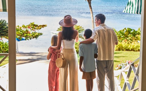 a group of people standing on a deck overlooking a body of water
