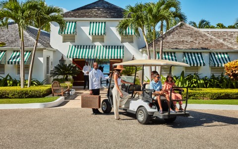 a group of people in a golf cart