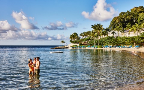 a group of people standing in water