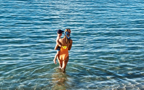 a woman and child in the water