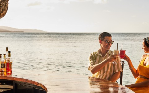 a man and woman drinking at a bar