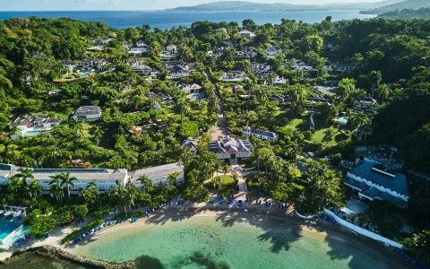 a aerial view of a beach with houses and trees