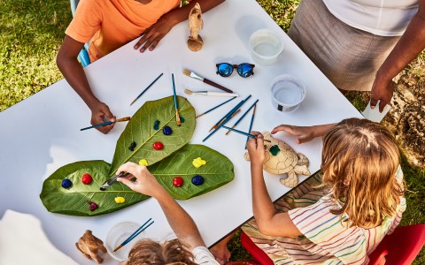 a group of kids painting on leaves