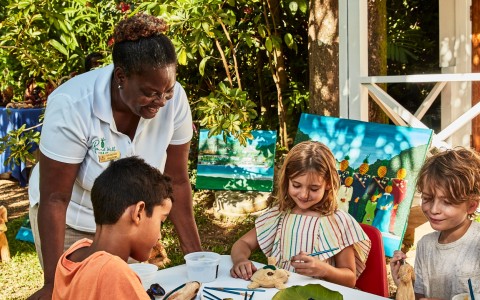 a woman and children painting
