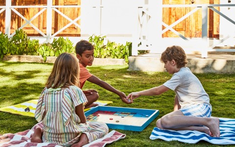 a group of kids playing a board game