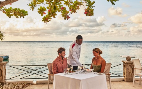 a group of people sitting at a table with food on it