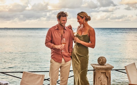 a man and woman holding wine glasses