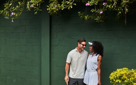 a man and woman holding tennis rackets